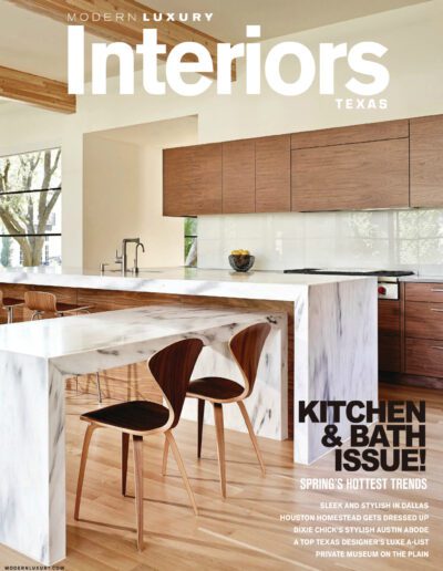 Modern kitchen interior with wooden accents and marble countertops featured in a luxury design magazine.