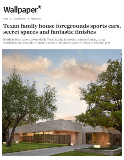 Modern residential architecture featuring a large suburban home with wood paneling, surrounded by lush trees and a landscaped garden.