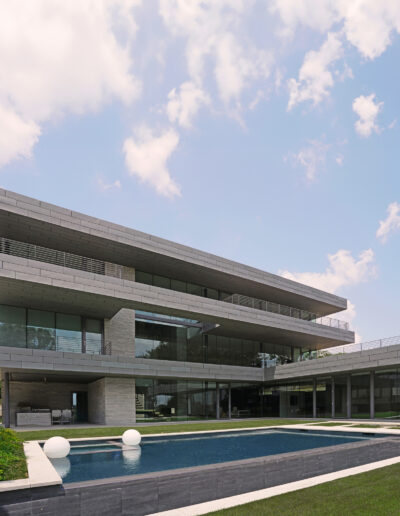 Modern architectural residence with tiered design and outdoor swimming pool.