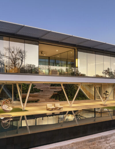 Exterior of luxurious modern home with huge windows.