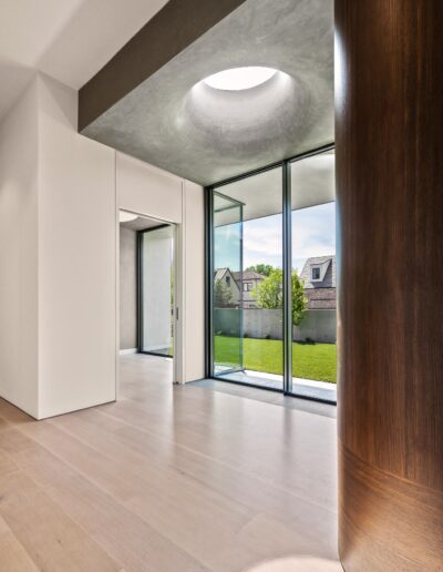 Modern walkway with floor to ceiling glass windows.